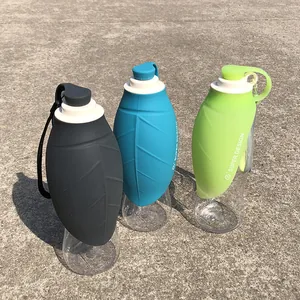 Portable leaf-shaped pet water bottles in grey, blue, and green for outdoor dog walking
