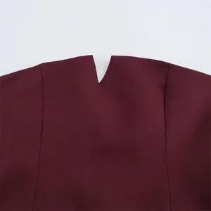 Close-up of the V-notch neckline detail on a minimalist burgundy tube top