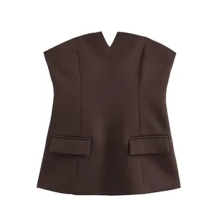 Detail shot of brown strapless tube top featuring V-notch neck and flap pockets