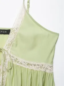 Detailed macro view of a light green lace camisole showing delicate fabric and trim