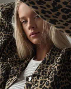 Close-up detail of a vintage leopard print denim jacket with lapel and white ribbed inner
