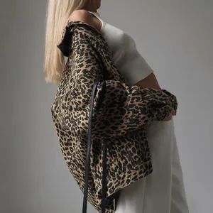 Close-up view of women's retro leopard print denim jacket with a stylish loose fit