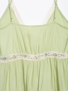 Detail of light green camisole top showing delicate white lace trim and gathered fabric