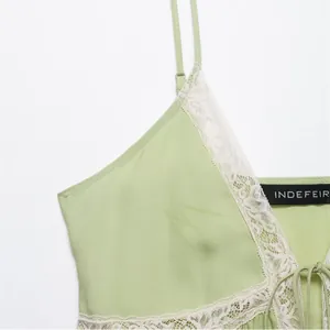 Light green lace camisole top with thin adjustable straps and elegant tie-front detail