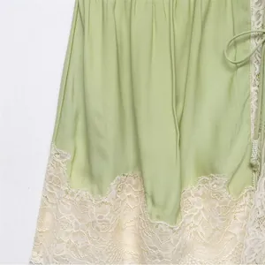 Light green spring summer camisole top featuring delicate cream floral lace trim details