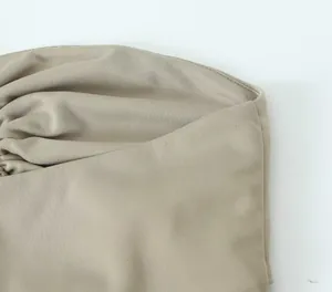 Detailansicht des glatten beige Stoffs und der feinen Nähte eines Damen-Bandeau-Tops