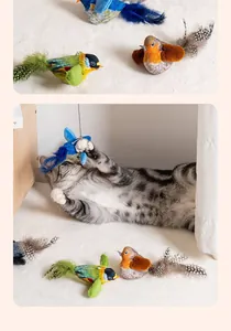 Close-up of a grey tabby cat playing with a realistic chirping bird toy with feathers