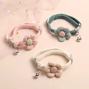 Detailed view of three cute adjustable pet collars with soft knitted flowers and silver bells