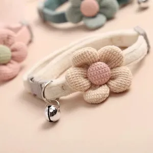 Detailed view of a cute knitted flower pet collar with a silver bell and buckle