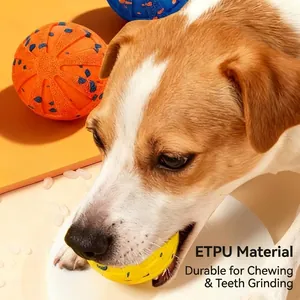 Durable ETPU dog toy ball for aggressive chewers shown in a close-up biting scene