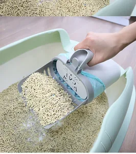 Action shot of integrated cat litter scooper with a built-in waste bag dispenser