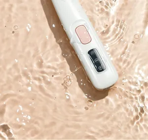 Close-up detail of professional waterproof pet hair clipper showing LED icons in water