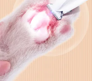 Close-up of electric pet paw trimmer with LED light trimming cat paw hair