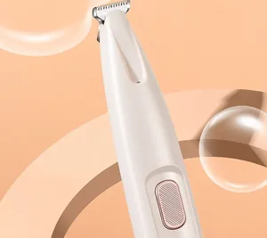 Close-up detail of a pet hair trimmer featuring a precision blade and rose gold switch