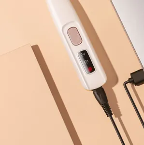 Detail view of pet clipper control panel with rose gold button and charging port