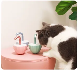 Macro shot of interactive electric tumbler cat toys with a curious bicolour cat