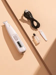 Professional pet hair trimmer kit with USB cable, brush and oil bottle on beige background