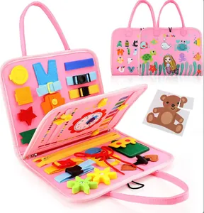 Close-up of pink felt Montessori busy board with buckles, gears, and zippers for kids