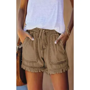 Close-up of khaki casual high-waist drawstring denim shorts with frayed fringe hem