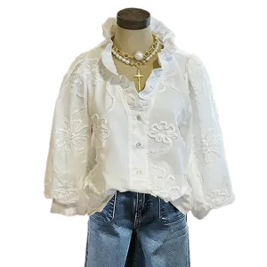 Elegant white V-neck blouse featuring floral embroidery, ruffle collar and puff sleeves