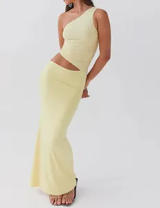 Elegant pale yellow one-shoulder knit top and maxi skirt set with waist cutout detail