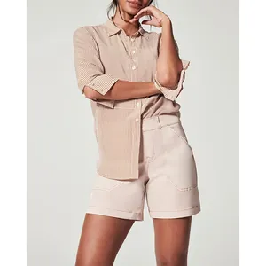 Stylish women's high-waisted stretch twill denim shorts in pale pink with pockets