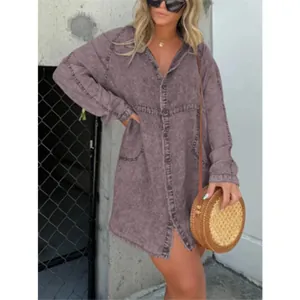 Fashionable model wearing a vintage purple acid wash V-neck denim shirt dress outdoors.