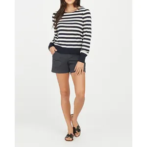 Casual women's elastic twill canvas shorts styled with a striped sweater and sandals
