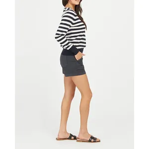 Side view of comfortable dark denim shorts for women styled in a casual summer outfit
