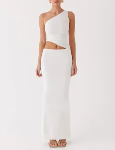 Detailed macro view of elegant white one-shoulder knit maxi dress with side cut-out