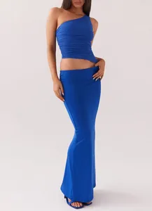 Detailed view of women's royal blue one-shoulder ruched knit top and skirt set.