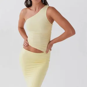 Pale yellow slim-fit one-shoulder top and matching knit skirt two-piece set