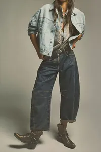 Full-body view of women's wide-leg loose denim jeans with a vintage washed finish