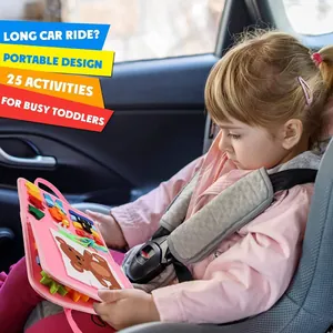 Bambina usa un libro Montessori rosa portatile durante un lungo viaggio in macchina.