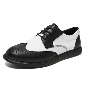 Detail of men's black and white leather brogue shoes with wingtip perforations