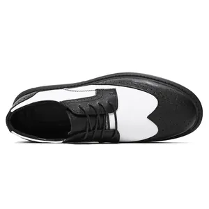 Top view of black and white men's Brogue leather shoes with perforated details