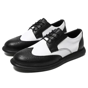 Detailed view of black and white wingtip Brogue shoes for men in a formal business style.