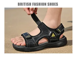Gros plan de sandales d'extérieur en cuir noir pour hommes avec velcro sur sable.