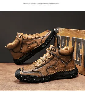 Detail view of men's brown leather Martin boots with distinctive handmade stitching.