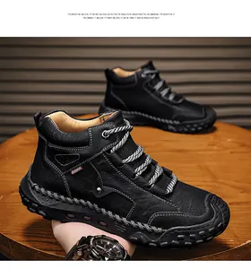 Detailed side view of black handmade stitched leather boots for men with round laces.