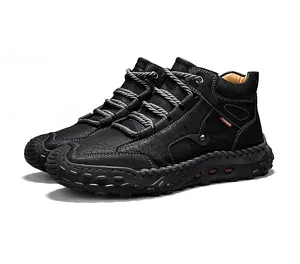 Side view detail of black leather high-top boots with durable hand-stitched rubber sole