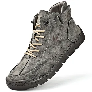 Detailed macro view of men's hand-stitched outdoor Martin boots in vintage grey leather.