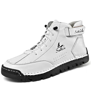 Close-up detail of white men's Martin boots with handmade stitching and black lug sole