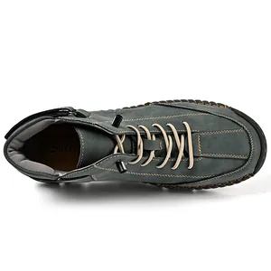 Top-down view of a grey suede men's high-top boot with cream laces and hand-stitched details