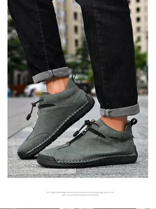 Detailed view of hand-stitched grey outdoor casual leather boots with front zipper