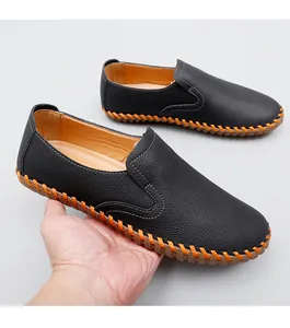 Detail view of hand-stitched black leather loafers with flexible sole for men.