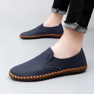 Men's navy blue casual slip-on loafers with decorative orange hand-stitching detail.