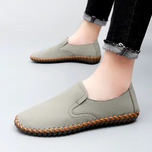 Men's grey hand-stitched leather loafers with soft soles and casual slip-on design.