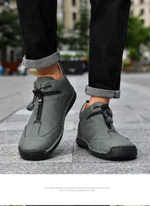 Close-up of men's casual leather boots with hand-stitched details and front zipper.
