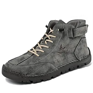 Side detail view of grey high-top leather outdoor boots with sturdy handmade stitching